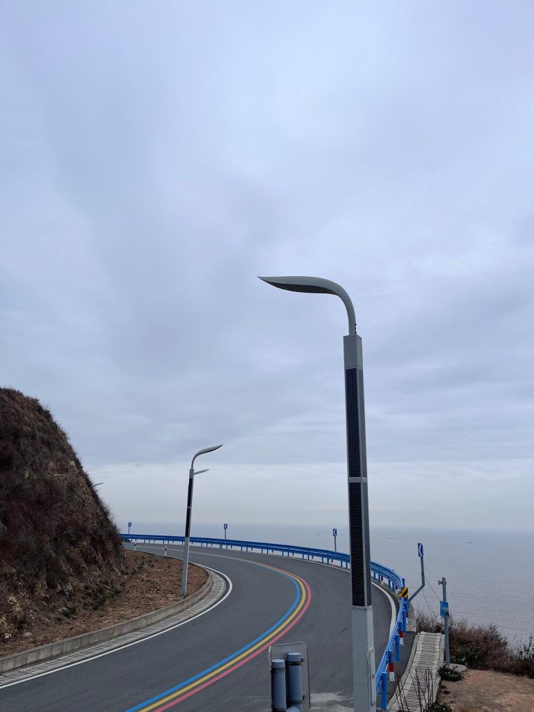 SolarPath solar street light on a coastal cliff road overlooking the sea